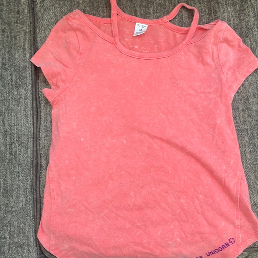 Bright pink shirt shoulder showings strap. With words real life unicorn!🦄